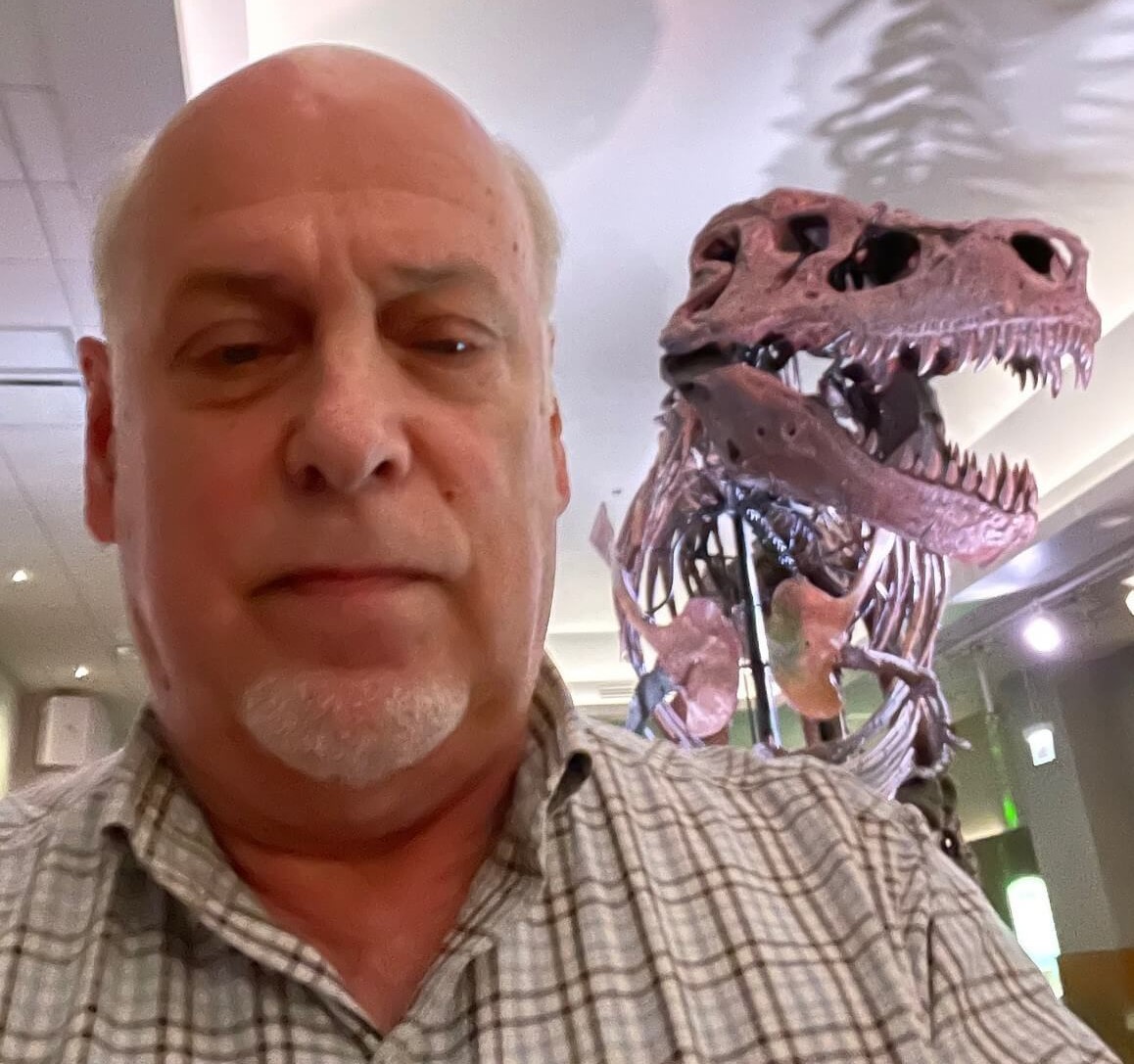 BOB GENHEIMER with dinosaur bones in background