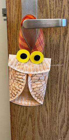 Folded paper plate decorated to look like an owl