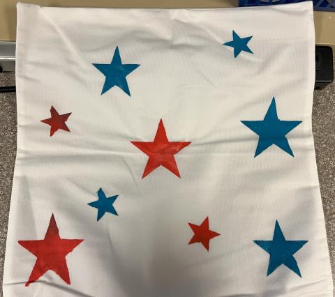 Pillow case with stars stenciled on it