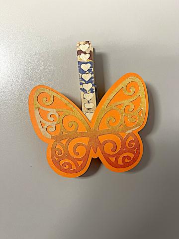 Paper butterfly on clothes pin with magnet