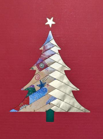 Card made with iris folding in the shape of a Christmas tree.