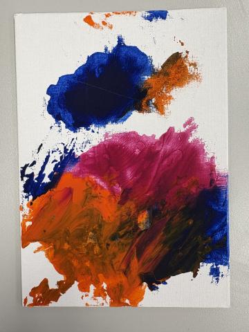 White canvas with blue, orange and pink paint 