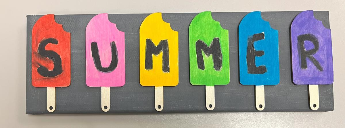 Painted popsicle cut-outs glued on a canvas