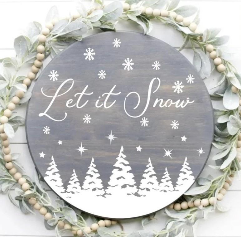 12-inch wood door hanger sign that says Let it Snow with snowflakes and trees.